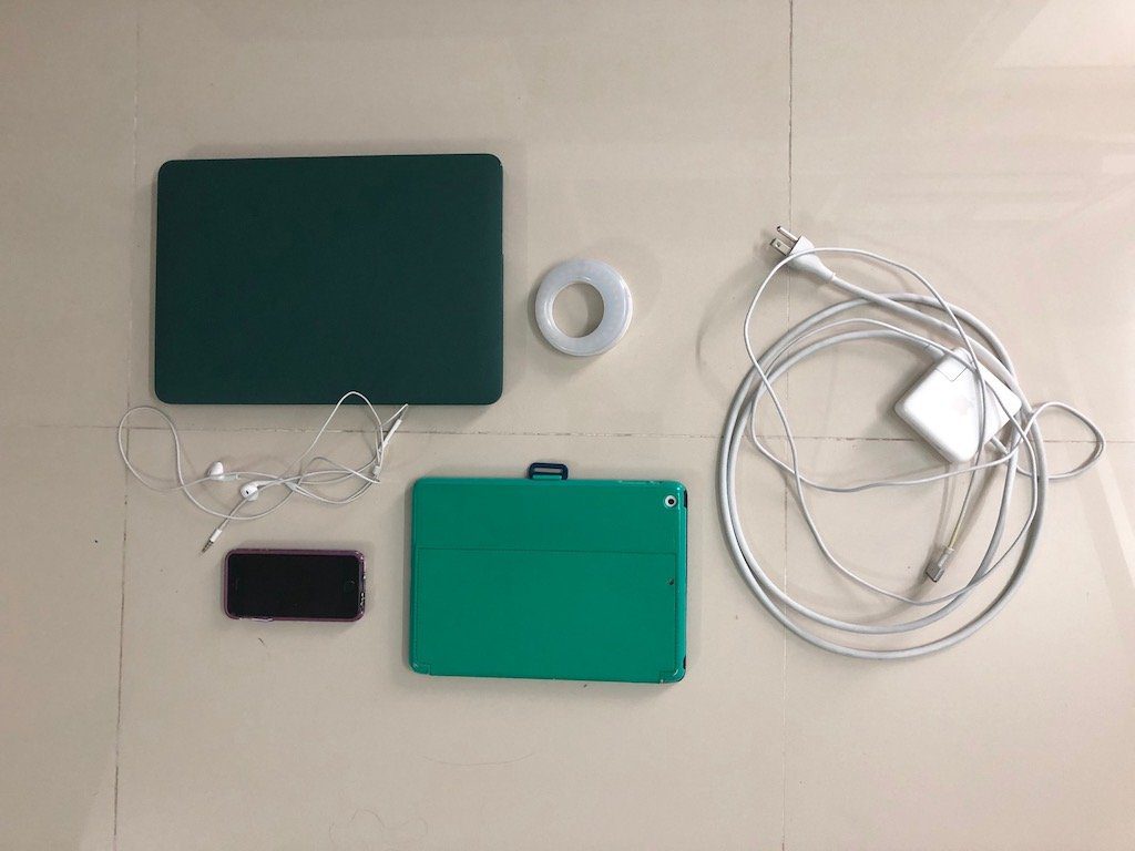 teaching english online in a power outage gear, a laptop, tablet, selfie ring light, charger, and hotspot phone