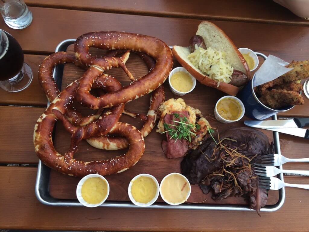 large pretzels and pub food on a wooden table in Birmingham Alabama