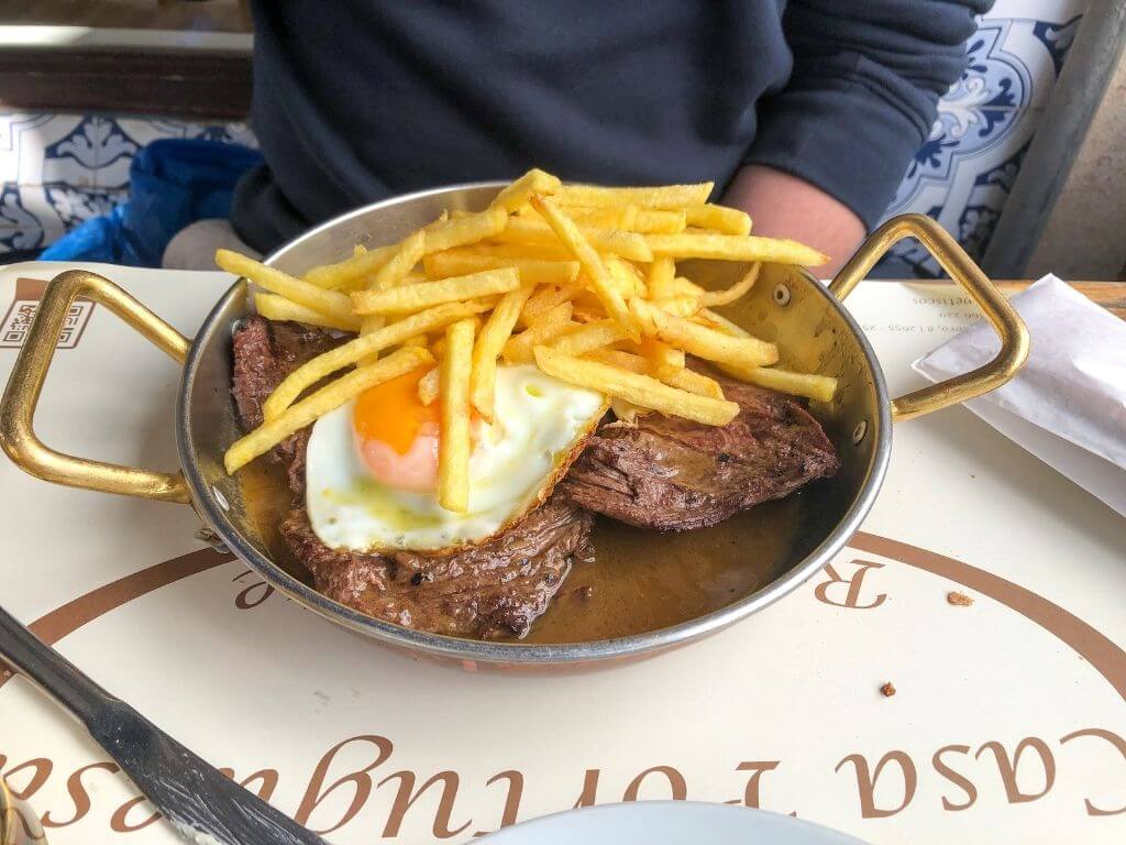 Steak with an egg and fries at Casa Portuguesa