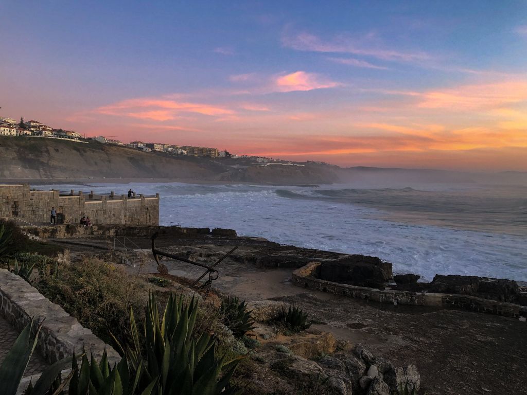 Sunset over the ruins of Furnas with the sea and cliffs in the background