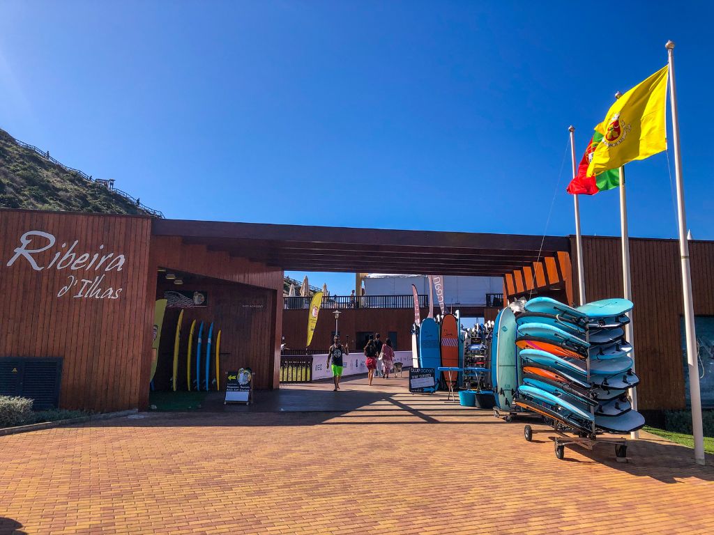 Racks of surfboards outside a surf school at Ribeira D'Ilhas beach