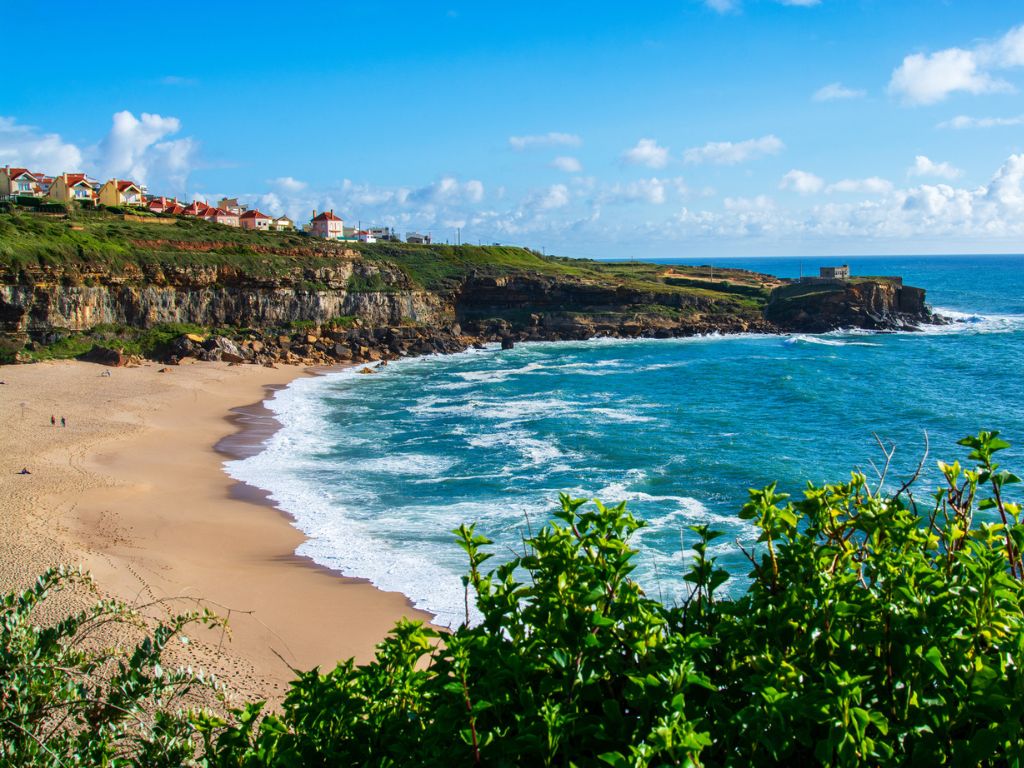 Sao Lorenco Beach surrounded by cliffs with small houses overlooking the sea