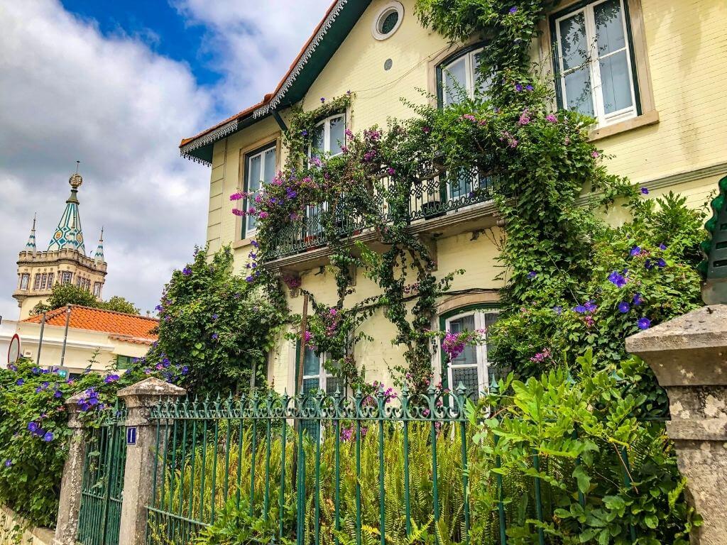Yellow house in Sintra old town covered in flowers