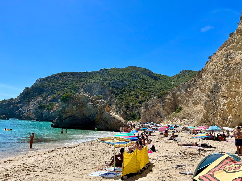 Sunbathers on the secret beach in Seisembra, one of the best Portugal hidden gems